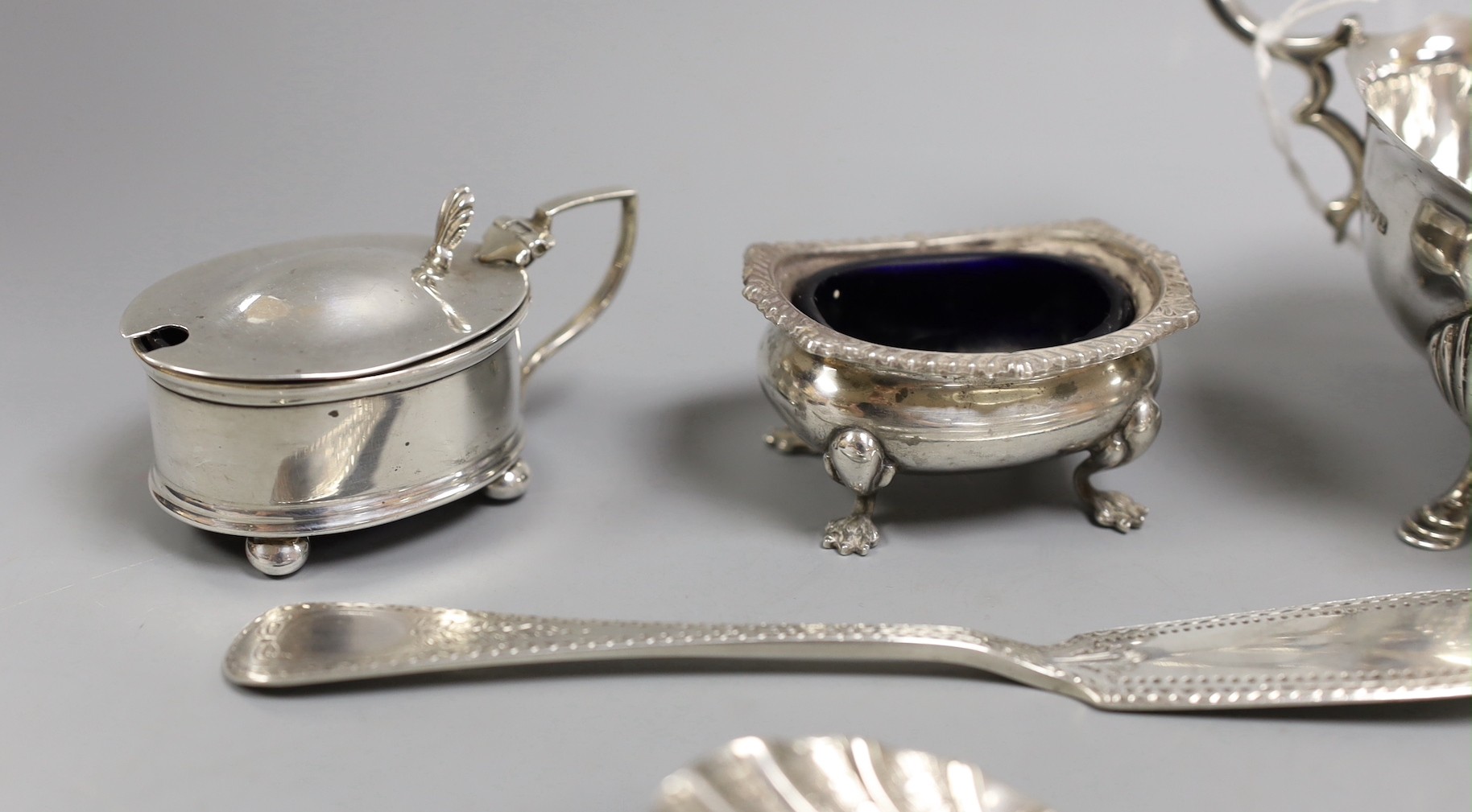 A George V silver sauce boat, Chester 1911, together with four silver condiments, a Georgian silver sauce ladle by William Bateman and four other items of silver cutlery.